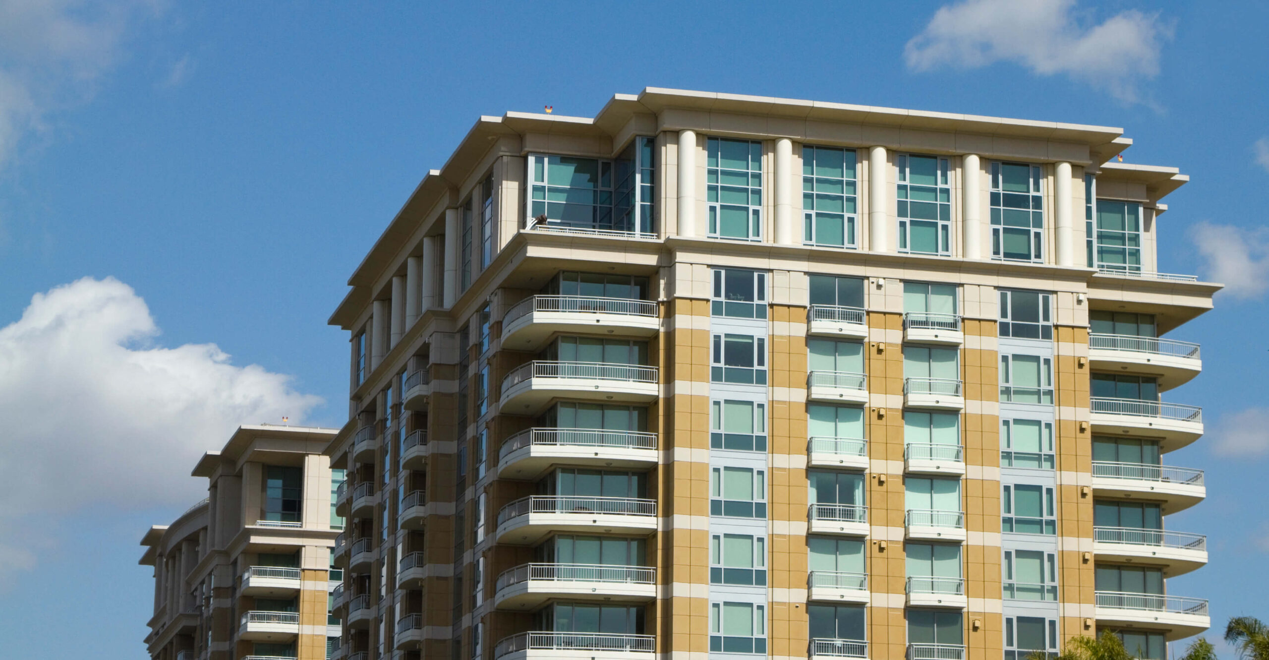 Modern apartment building under clear blue sky.