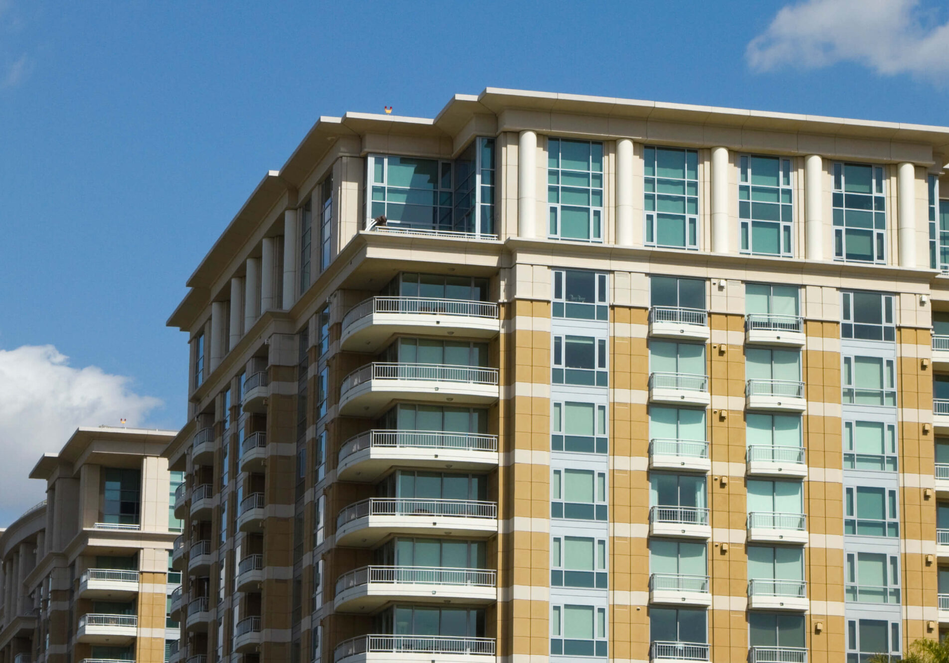 Modern apartment building under clear blue sky.